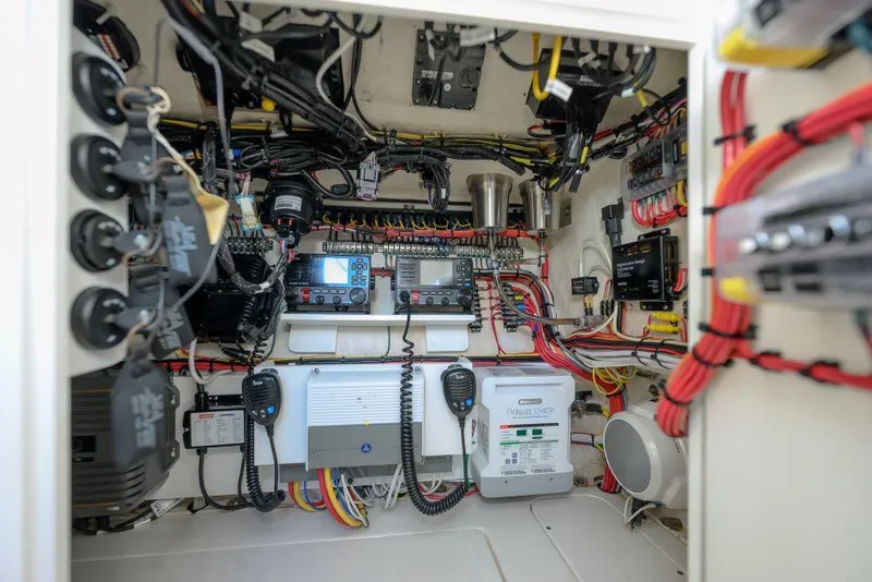 Slide: The Image of Interior view of 2022 SeaVee 390Z boat's electrical system with wiring and control panels. - 24