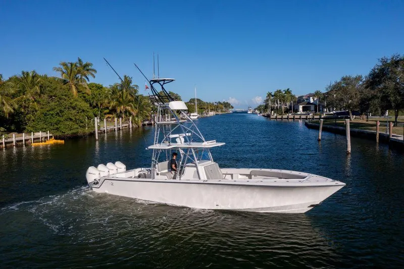 Slide: The Image of 2022 SeaVee 390Z boat cruising on a scenic waterway with palm trees. - 3