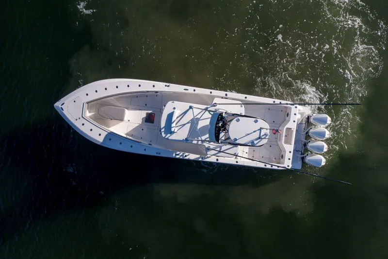 Slide: The Image of Aerial view of 2022 SeaVee 390Z boat with triple engines on water. - 8