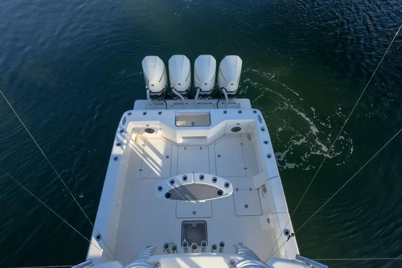 Slide: The Image of 2022 SeaVee 390Z boat with four outboard engines on calm water. - 9