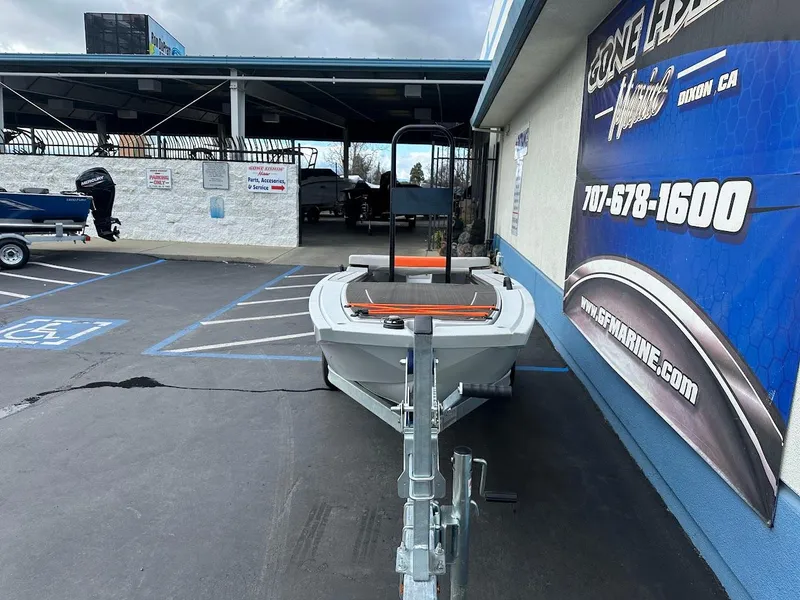 Slide: The Image of Boat trailer parked outside a marine store, featuring a 2023 Veer V13 model. - 3