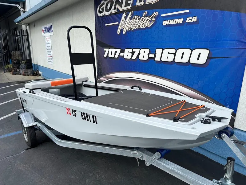 Slide: The Image of 2023 Veer V13 boat on trailer, displayed outside a marine shop. - 5