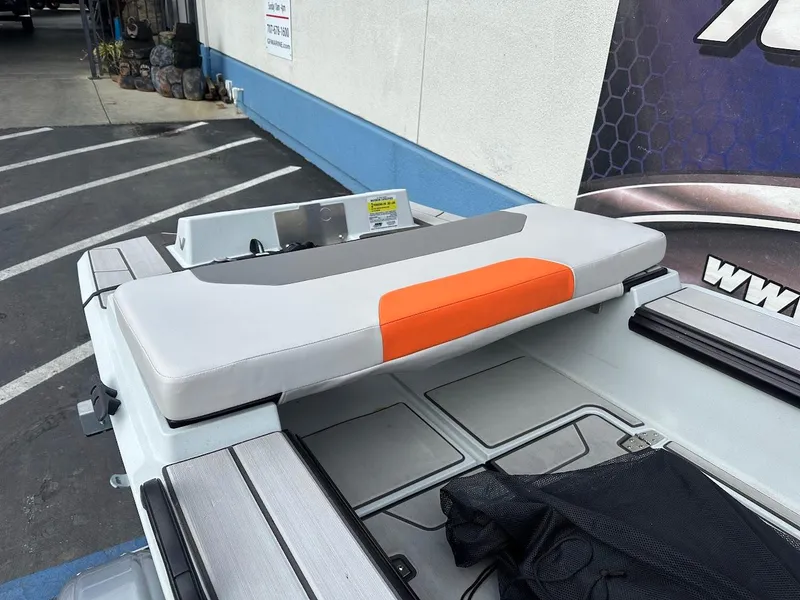 Slide: The Image of 2023 Veer V13 boat seat with orange accent, parked near a building. - 9