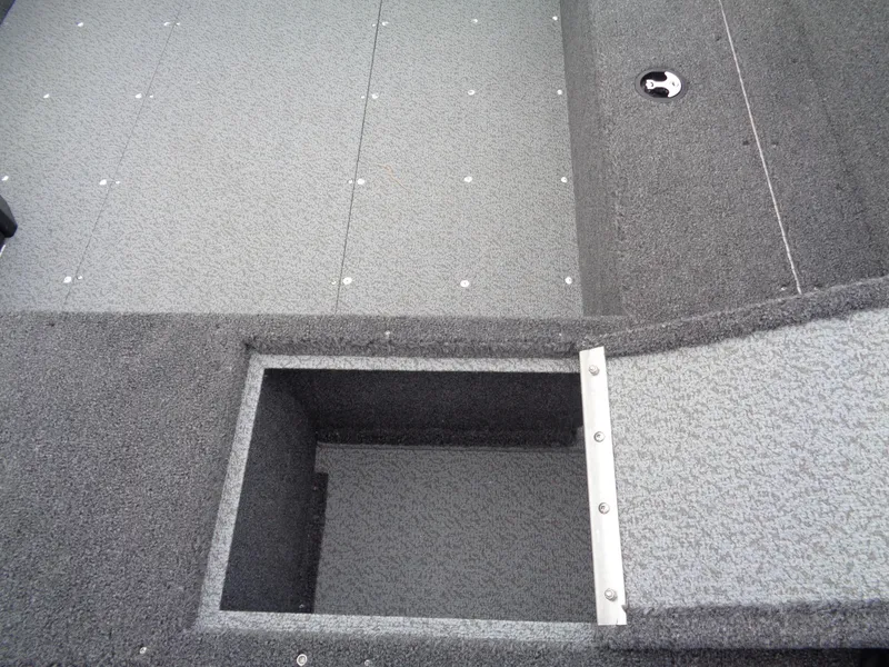 Slide: The Image of 2025 Lund 1650 Rebel XL Tiller boat interior with storage compartment. - 12