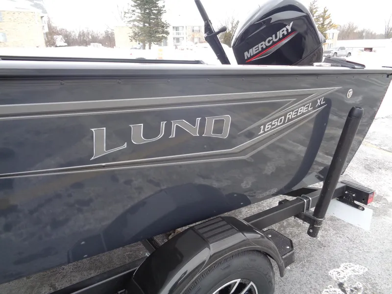 Slide: The Image of 2025 Lund 1650 Rebel XL Tiller boat with Mercury engine on trailer. - 3