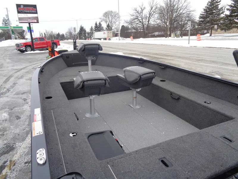 Slide: The Image of 2025 Lund 1650 Rebel XL Tiller boat with dual seats on a snowy roadside. - 5