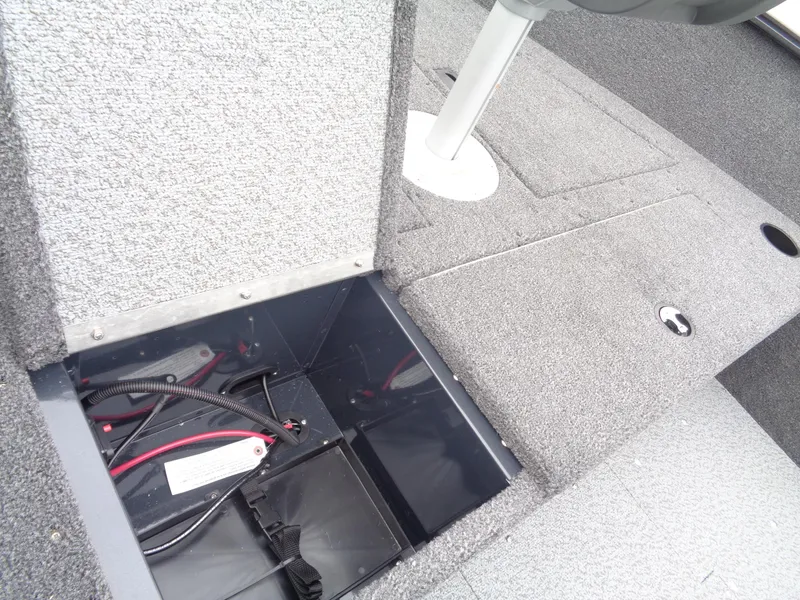 Slide: The Image of 2025 Lund 1650 Rebel XL Tiller boat interior showing open storage compartment. - 7