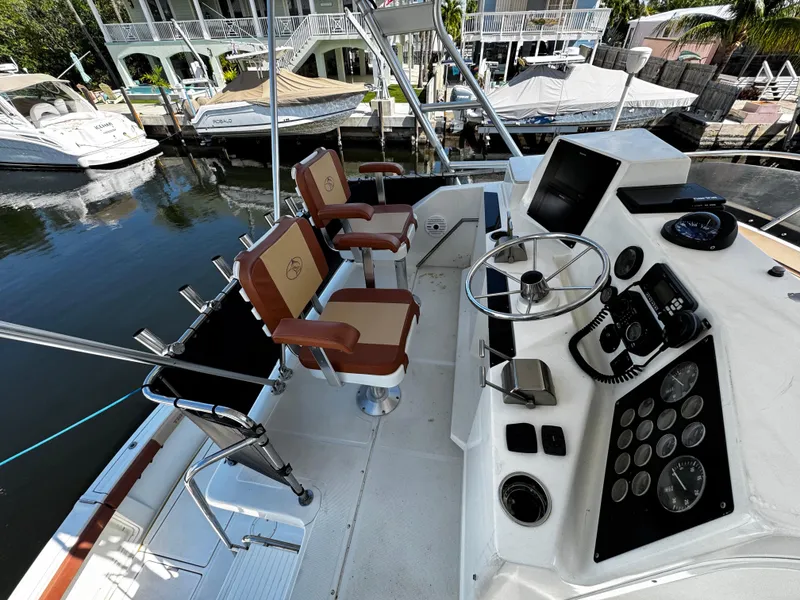 Slide: The Image of 1991 Tiara Yachts 3600 Convertible helm with dual seats and control panel. - 10