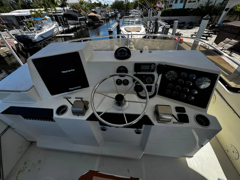 Slide: The Image of 1991 Tiara Yachts 3600 Convertible helm with steering wheel and control panel. - 12