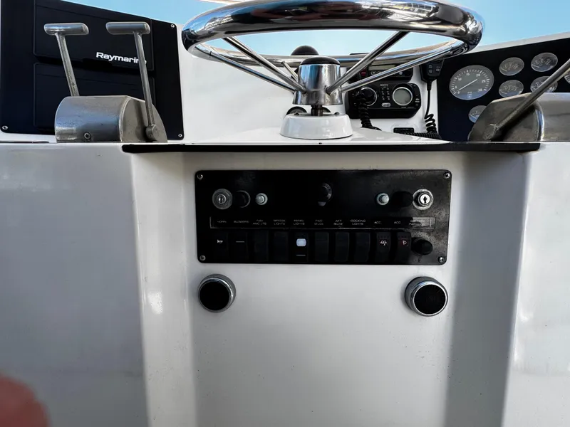 Slide: The Image of 1991 Tiara Yachts 3600 Convertible helm with steering wheel and control panel. - 16