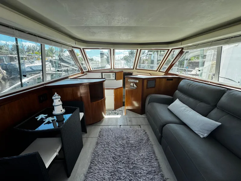 Slide: The Image of Interior of 1991 Tiara Yachts 3600 Convertible with modern seating and panoramic windows. - 21