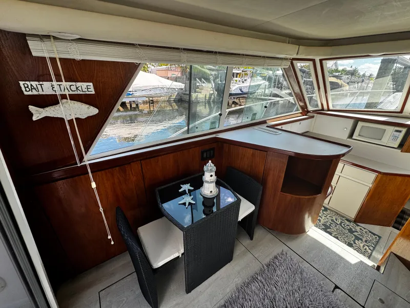 Slide: The Image of Interior of 1991 Tiara Yachts 3600 Convertible with dining area and kitchenette. - 22