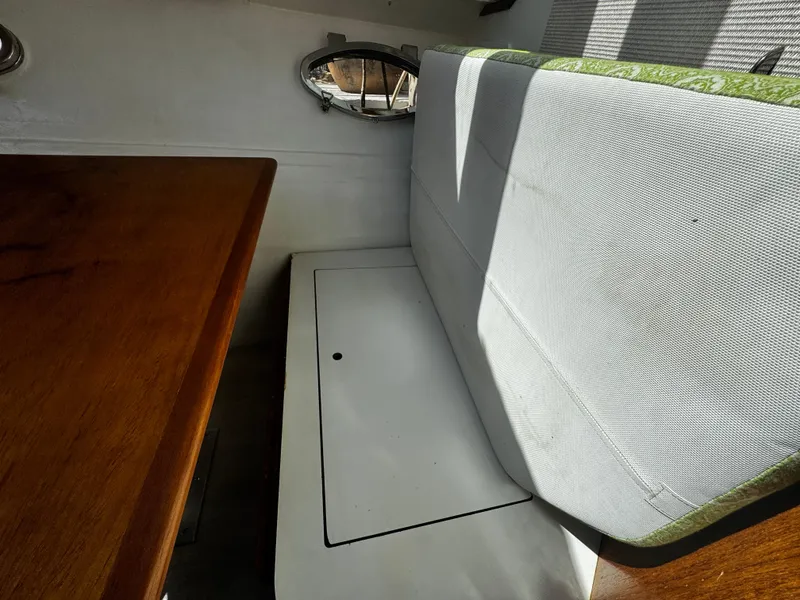 Slide: The Image of Interior seating area of a 1991 Tiara Yachts 3600 Convertible with wooden table. - 25