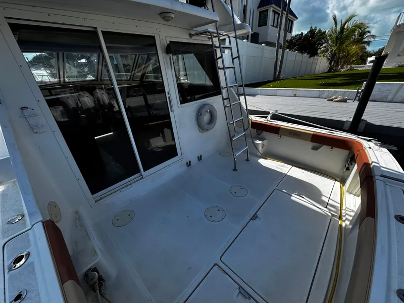 Slide: The Image of 1991 Tiara Yachts 3600 Convertible boat deck with ladder and seating area. - 3