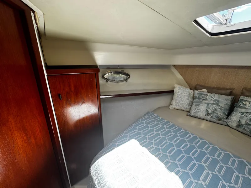 Slide: The Image of Cozy cabin interior of 1991 Tiara Yachts 3600 Convertible with bed and wooden cabinetry. - 30