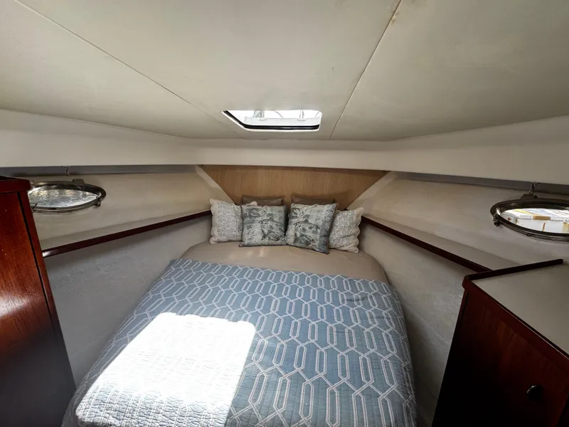 Slide: The Image of 1991 Tiara Yachts 3600 Convertible cabin with bed, pillows, and overhead hatch. - 31