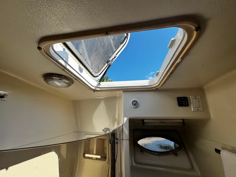 Slide: The Image of Interior view of 1991 Tiara Yachts 3600 Convertible with open hatch and natural light. - 35