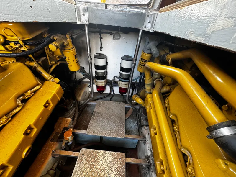 Slide: The Image of Engine room of 1991 Tiara Yachts 3600 Convertible, showcasing yellow machinery and components. - 37
