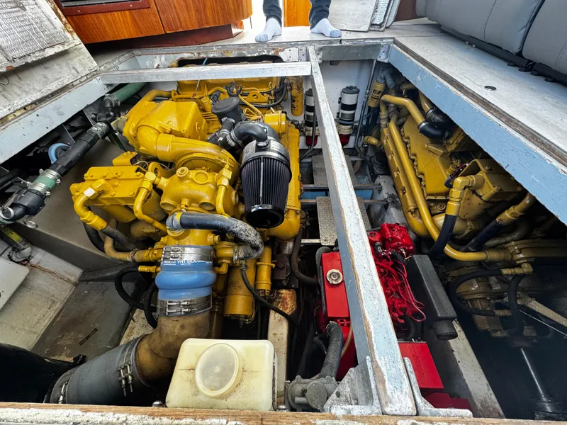 Slide: The Image of Engine compartment of a 1991 Tiara Yachts 3600 Convertible, showcasing yellow machinery and components. - 38
