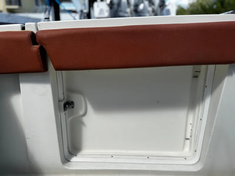 Slide: The Image of 1991 Tiara Yachts 3600 Convertible interior detail with brown cushion and storage compartment. - 4