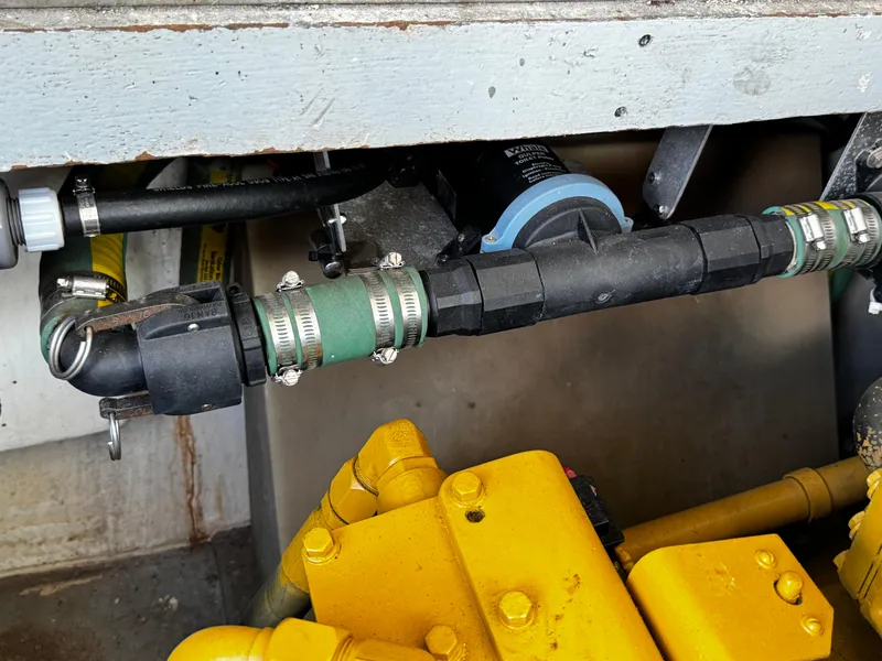 Slide: The Image of Engine compartment of a 1991 Tiara Yachts 3600 Convertible, showing hoses and yellow machinery. - 40