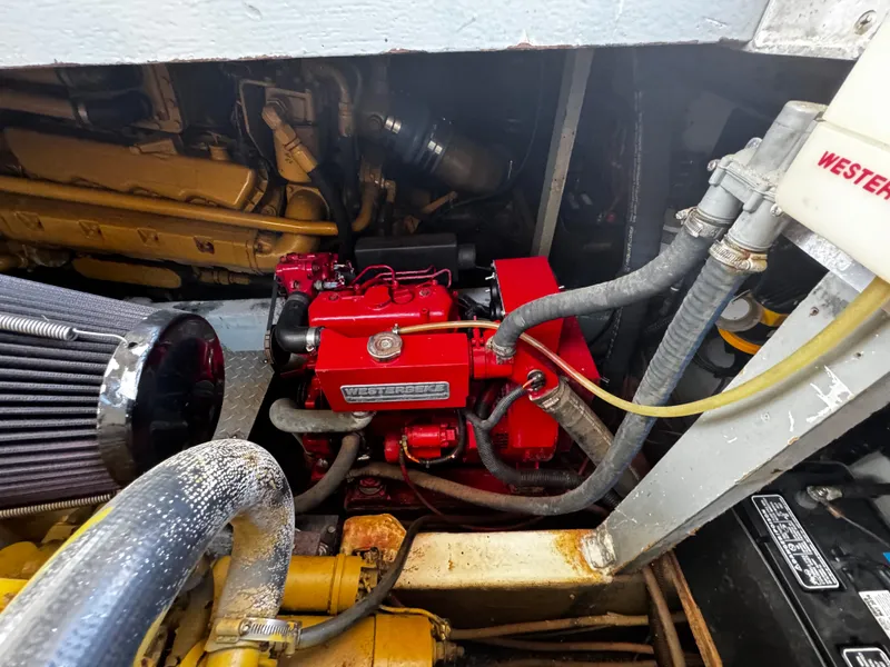 Slide: The Image of Engine compartment of a 1991 Tiara Yachts 3600 Convertible, featuring a red engine component. - 41