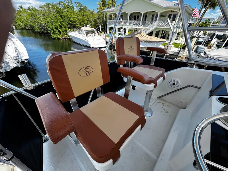 Slide: The Image of 1991 Tiara Yachts 3600 Convertible boat seats, docked near waterfront homes. - 8
