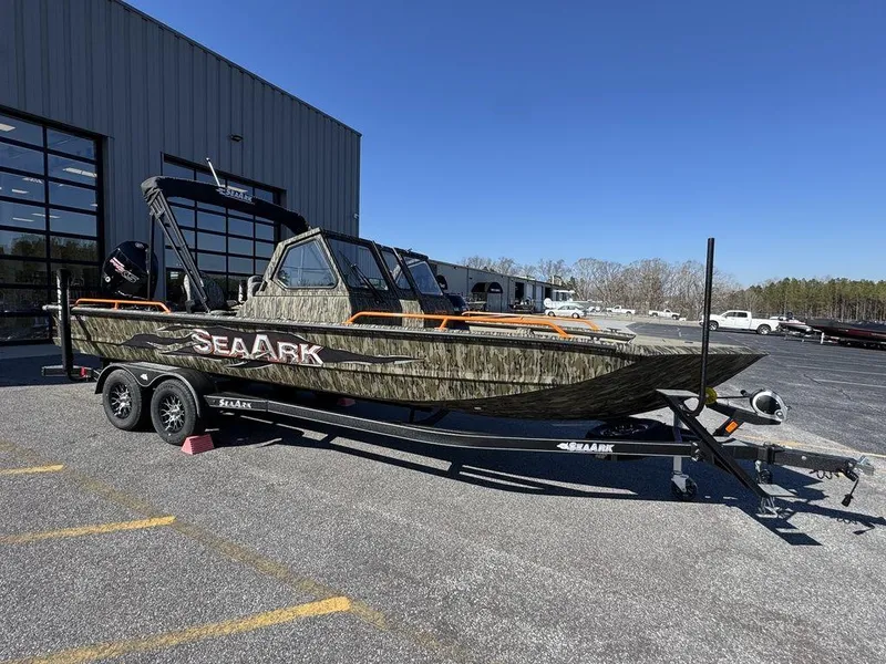 The Image of 2025 SeaArk ProCat 240 boat on trailer, parked outdoors near a building. - 1