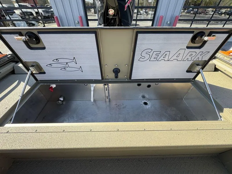 Slide: The Image of 2025 SeaArk ProCat 240 boat storage compartment with open lid, showcasing interior space. - 12