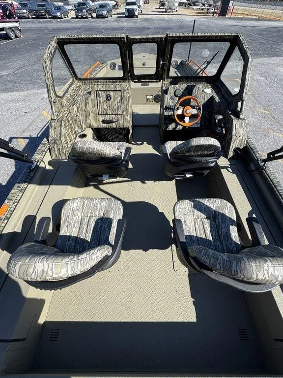 Slide: The Image of 2025 SeaArk ProCat 240 boat interior with camo seats and steering wheel. - 14