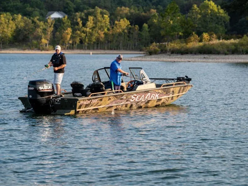 Slide: The Image of 2025 SeaArk ProCat 240 boat on a lake with two people fishing. - 19