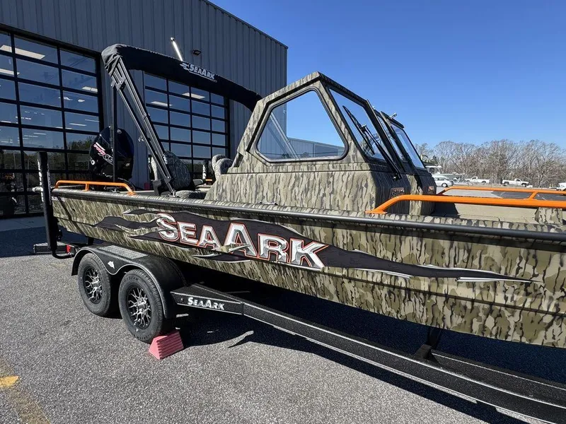 Slide: The Image of 2025 SeaArk ProCat 240 boat with camouflage design on a trailer. - 2