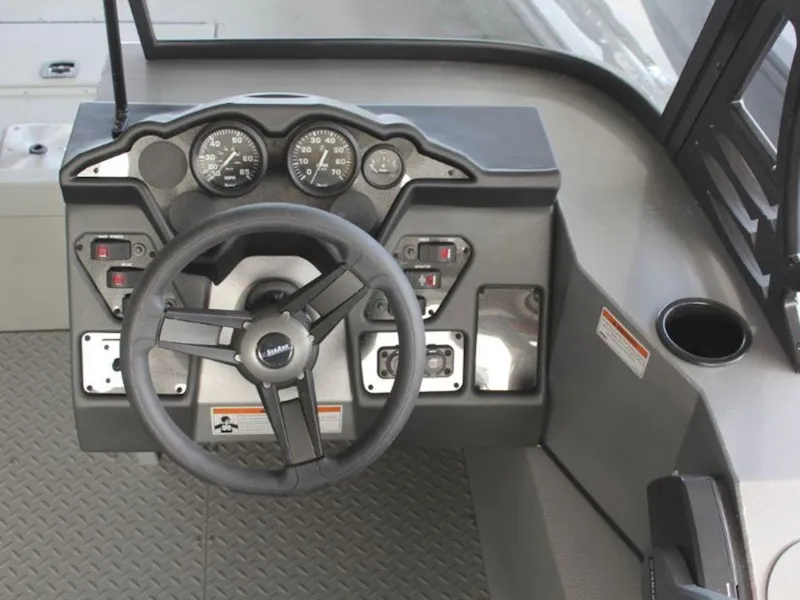 Slide: The Image of 2025 SeaArk ProCat 240 boat dashboard with steering wheel and gauges. - 21