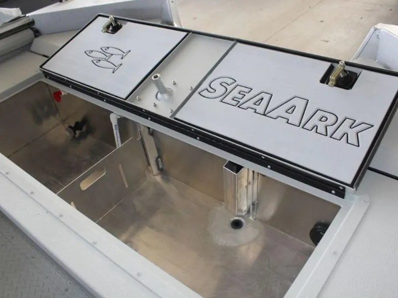 Slide: The Image of 2025 SeaArk ProCat 240 boat storage compartment with SeaArk branding and fish graphics. - 23