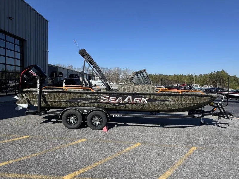 Slide: The Image of 2025 SeaArk ProCat 240 boat on trailer, camo design, parked outdoors. - 3