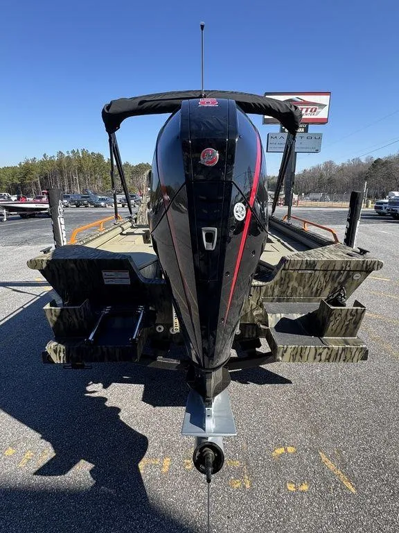 Slide: The Image of 2025 SeaArk ProCat 240 boat with powerful outboard motor, parked outdoors. - 5