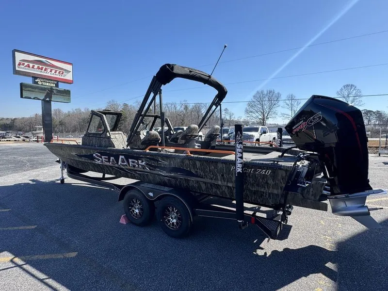 Slide: The Image of 2025 SeaArk ProCat 240 boat on trailer, parked outdoors under clear sky. - 7