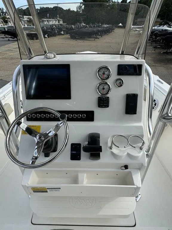 Slide: The Image of 2025 Key West 219fs boat dashboard with steering wheel, gauges, and electronic controls. - 10