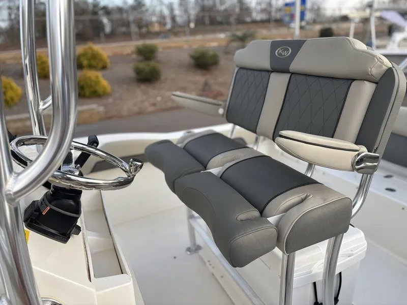 Slide: The Image of 2025 Key West 219fs boat interior with cushioned seating and steering wheel. - 11