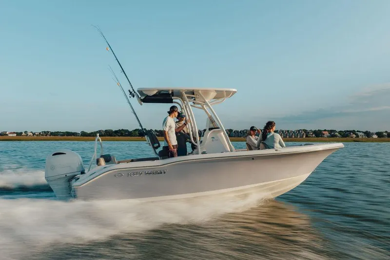 Slide: The Image of 2025 Key West 219fs boat cruising on water with passengers enjoying the ride. - 15