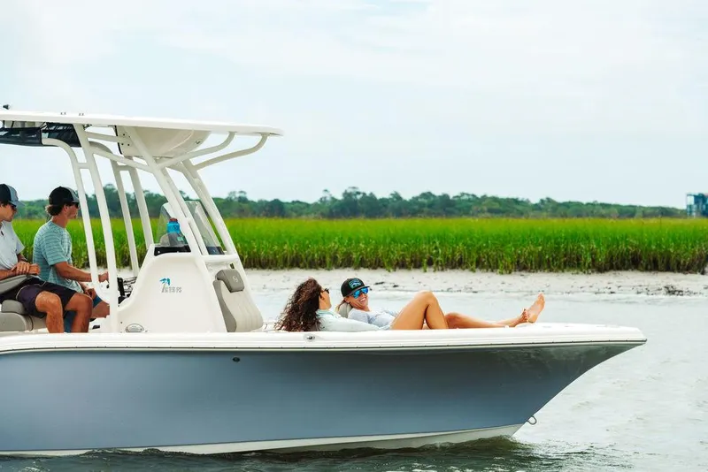 Slide: The Image of 2025 Key West 219fs boat cruising with passengers relaxing on deck. - 18
