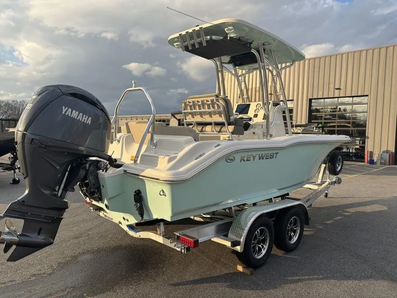 Slide: The Image of 2025 Key West 219fs boat on trailer with Yamaha outboard motor, parked outdoors. - 3