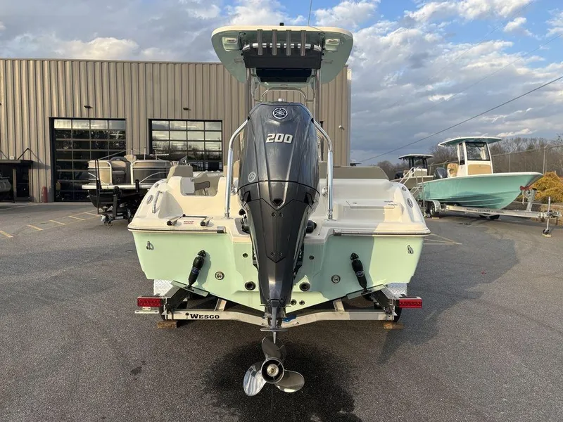 Slide: The Image of 2025 Key West 219fs boat with Yamaha 200 engine, parked outdoors. - 5