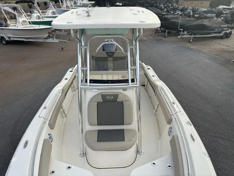 Slide: The Image of 2025 Key West 219fs boat, front view, featuring seating and T-top canopy. - 6