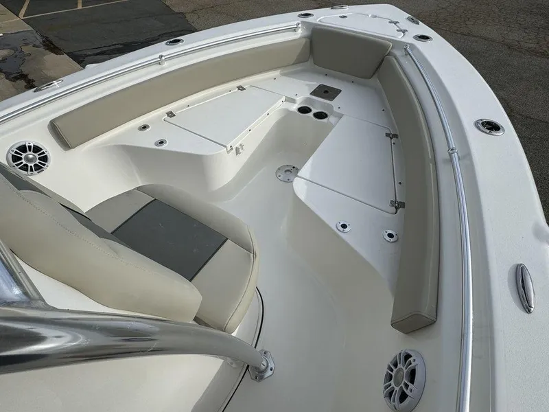 Slide: The Image of 2025 Key West 219fs boat interior with cushioned seating and storage compartments. - 9
