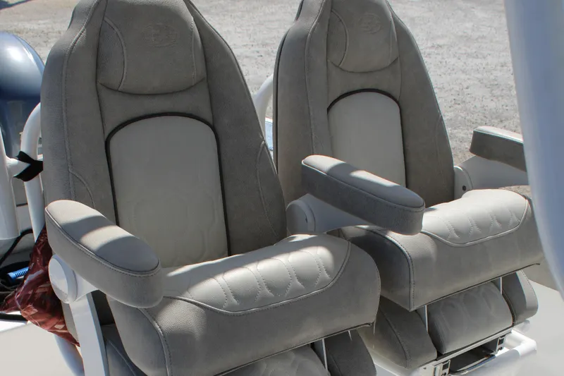 Slide: The Image of 2021 Sea Fox 268 Commander boat seats, featuring plush gray upholstery and armrests. - 13