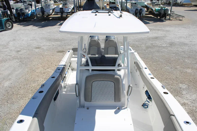 Slide: The Image of 2021 Sea Fox 268 Commander boat interior with seating and console, parked on gravel. - 34