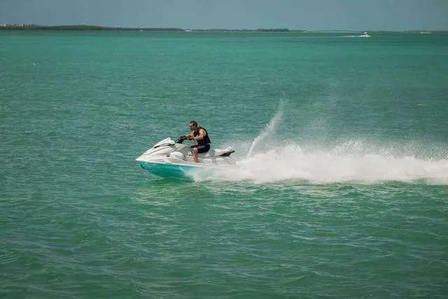 Slide: The Image of 2025 Yamaha Waverunner VX Cruiser HO with Audio speeding on turquoise water. - 18