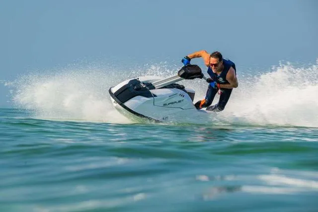 Slide: The Image of 2025 Yamaha Waverunner Superjet speeding on water, rider in action, creating splashes. - 16