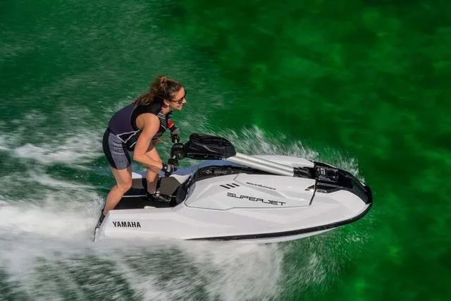 Slide: The Image of 2025 Yamaha Waverunner Superjet on green water, rider enjoying high-speed performance. - 18